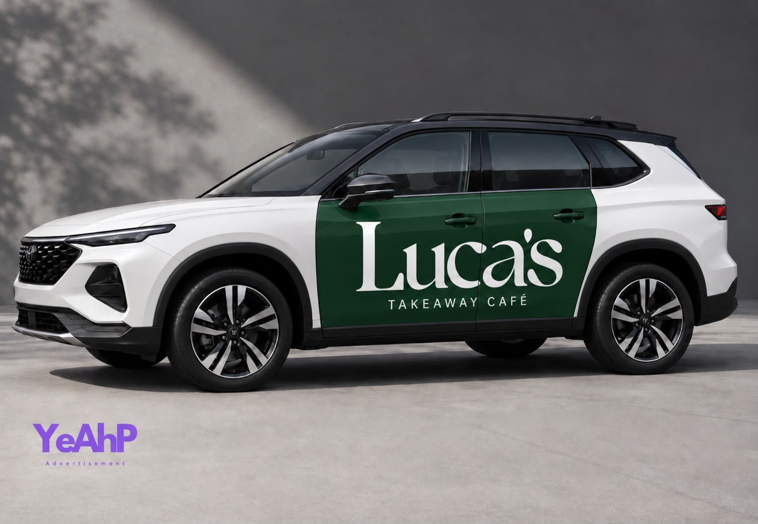 A white SUV with a dark green Luca's Takeaway Cafe wrap across both doors, with the YeAhP mark in the corner.